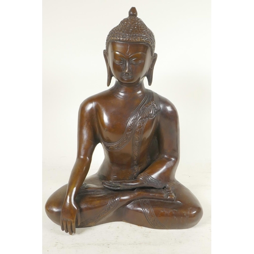 54 - A cast brass figure of Shakyamuni Buddha seated in meditation, 12