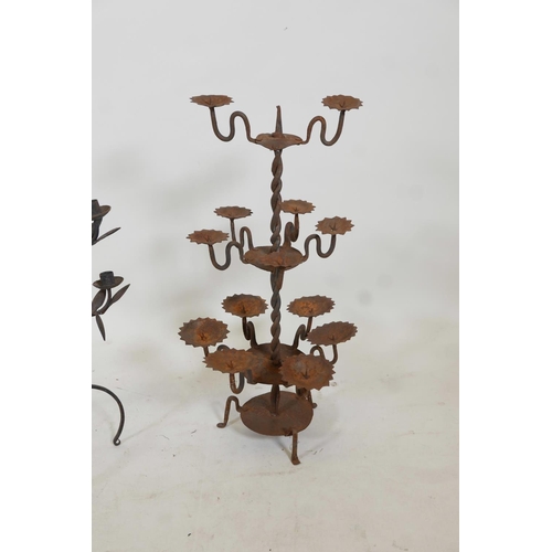 56 - A wrought iron eight branch candelabra with trailing leaf decoration, together with a thirteen branc... 