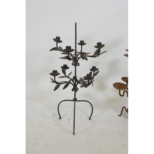 56 - A wrought iron eight branch candelabra with trailing leaf decoration, together with a thirteen branc... 