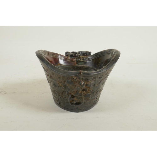 58 - A Chinese horn and imitation horn libation cup with carved kylin decoration, carved seal mark to bas... 