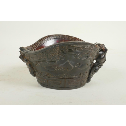 58 - A Chinese horn and imitation horn libation cup with carved kylin decoration, carved seal mark to bas... 