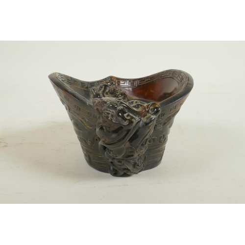 58 - A Chinese horn and imitation horn libation cup with carved kylin decoration, carved seal mark to bas... 