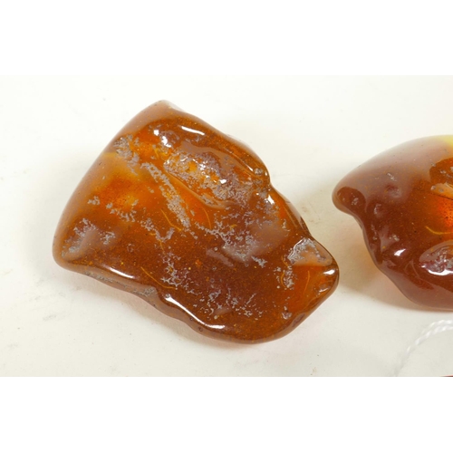 603 - A pair of cherry amber cufflinks, and two reconstituted amber shards, 2½