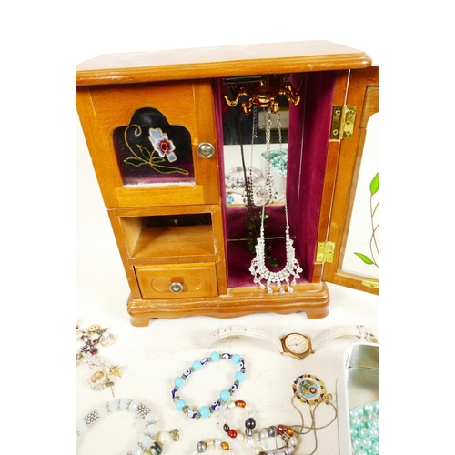 613 - A retro jewellery box in the form of a wardrobe containing costume jewellery, together with a small ... 