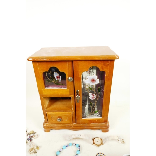 613 - A retro jewellery box in the form of a wardrobe containing costume jewellery, together with a small ... 