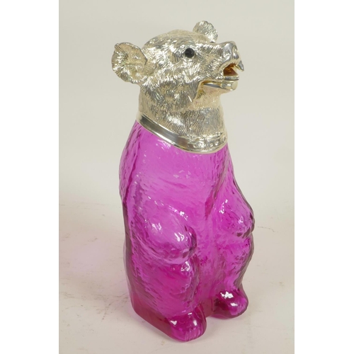 625 - A pale amethyst glass decanter in the form of a bear with silver plated head and glass eyes, 9