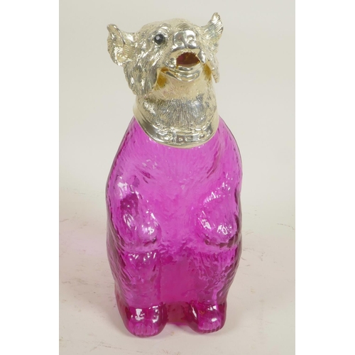 625 - A pale amethyst glass decanter in the form of a bear with silver plated head and glass eyes, 9