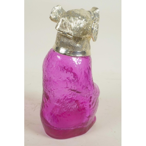 625 - A pale amethyst glass decanter in the form of a bear with silver plated head and glass eyes, 9