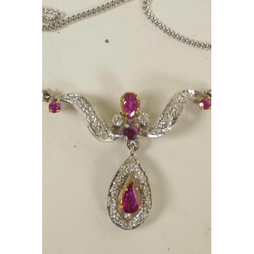 626 - A 9ct white gold, diamond and ruby pendant on a 9ct gold chain (5.6 grams)