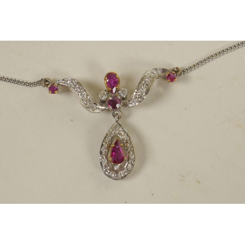 626 - A 9ct white gold, diamond and ruby pendant on a 9ct gold chain (5.6 grams)