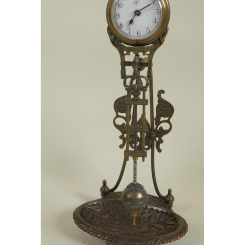 627 - A bronze mystery clock on floral tray base, 11