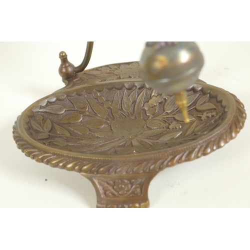 627 - A bronze mystery clock on floral tray base, 11