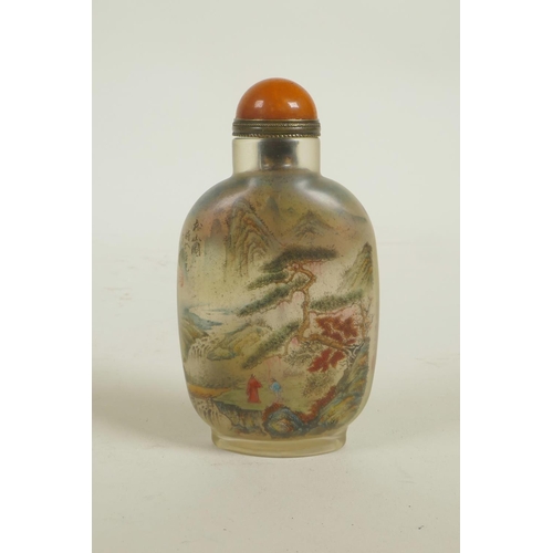 63 - A Chinese reverse decorated glass snuff bottle depicting figures in a mountain landscape and birds, ... 