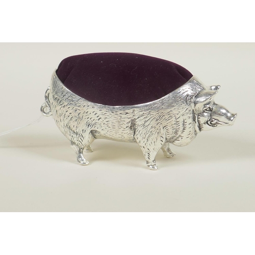 637 - A silver plated pincushion in the form of a pig, stamped 800, 4