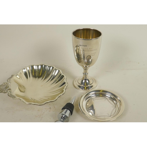 645 - A hallmarked silver trophy cup and pin tray, gross 123g, together with a shell shaped silver plated ... 