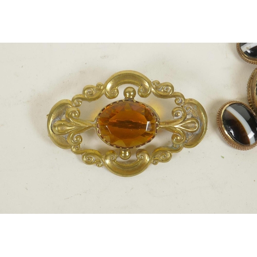 649 - A gilt metal and banded agate set pendant, and a gilt metal brooch set with an orange gemstone, 3½