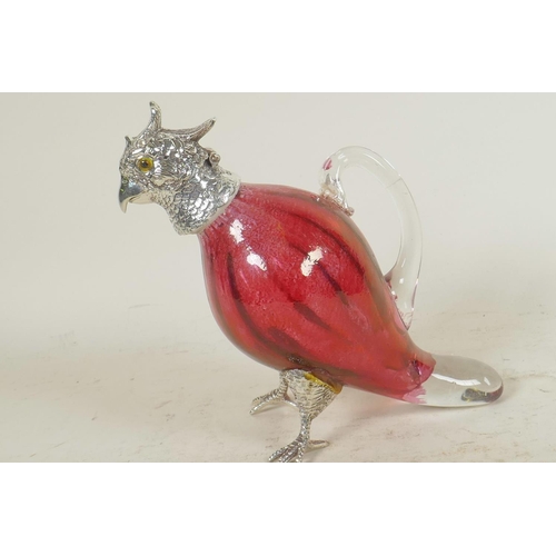 654 - A small cranberry glass decanter in the form of a parrot with silver plated head and feet, 6½