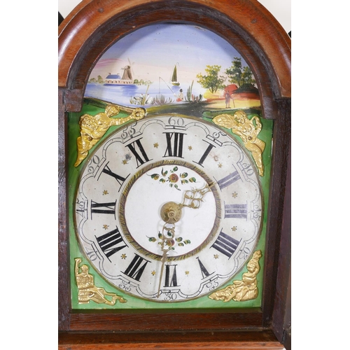 656 - A German oak cased wall clock with painted arched dial decorated with a fisherman, windmill and barg... 