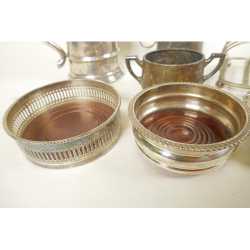 660 - Seven pieces of silver plated wares to include two wine bottle coasters with turned wood bases, 4¼