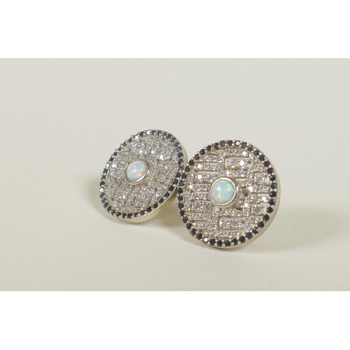 663 - A pair of silver earrings set with an opalite surrounded by cubic zirconium