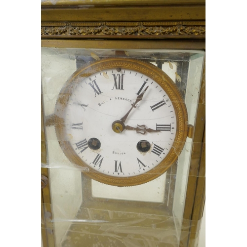 669 - An American brass cased four glass mantel clock with twin train movement striking on a gong, white e... 