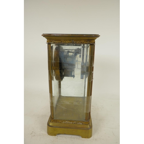 669 - An American brass cased four glass mantel clock with twin train movement striking on a gong, white e... 