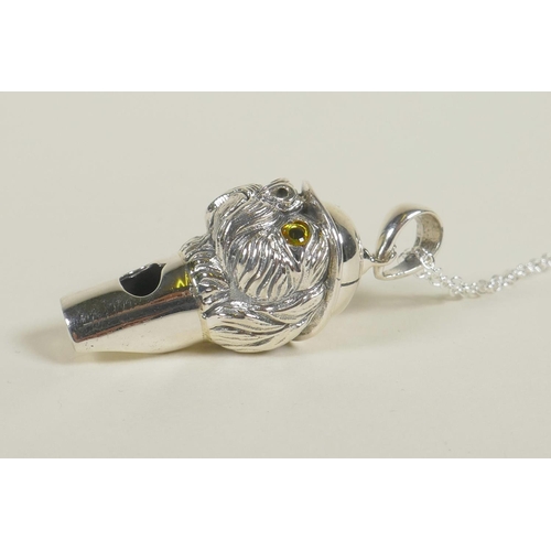 671 - A sterling silver whistle in the form of a dog in a hat, 1½