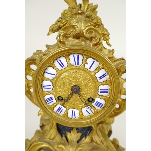 675 - An ormolu Rococo style mantel clock, the movement striking on a gong, with gilded dial and inset cer... 