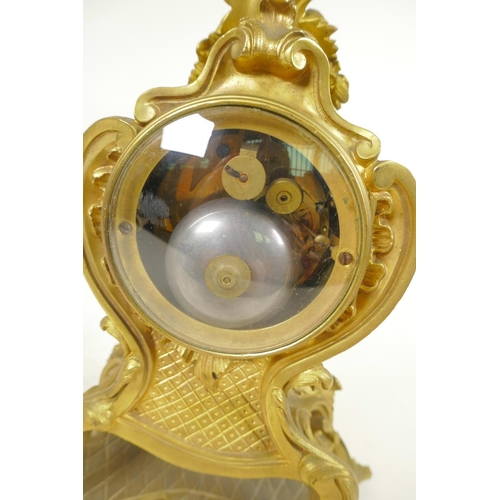 675 - An ormolu Rococo style mantel clock, the movement striking on a gong, with gilded dial and inset cer... 