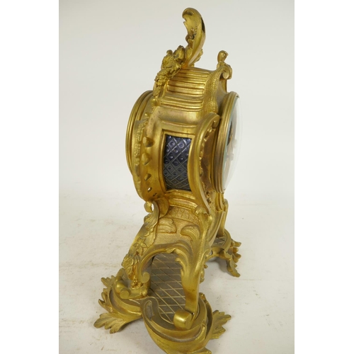 675 - An ormolu Rococo style mantel clock, the movement striking on a gong, with gilded dial and inset cer... 