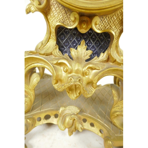 675 - An ormolu Rococo style mantel clock, the movement striking on a gong, with gilded dial and inset cer... 