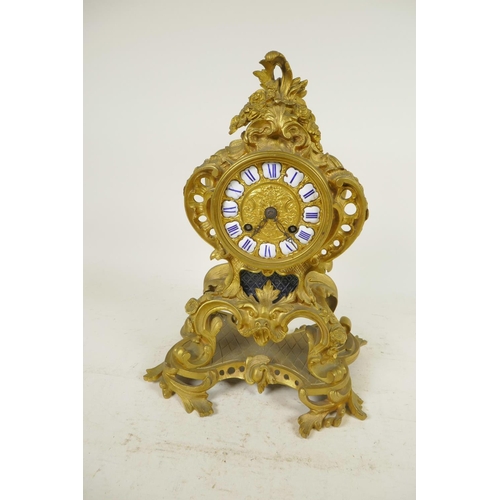 675 - An ormolu Rococo style mantel clock, the movement striking on a gong, with gilded dial and inset cer... 