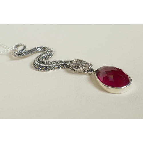 679 - A 925 silver pendant necklace in the form of a marcasite encrusted snake with a pear shaped red gems... 