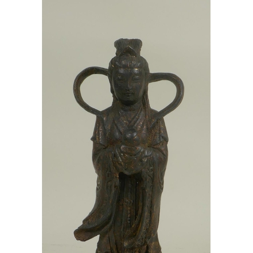 68 - A Chinese bronze of Quan Yin standing on a lotus throne, with a distressed gilt patina, impressed 4 ... 