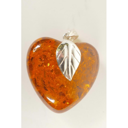 684 - A silver mounted faux amber heart shaped pendant, 1½