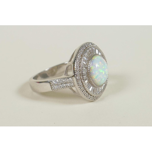 702 - A 925 silver dress ring set with an opalite encircled by cubic zirconium, approximate size 'Q'