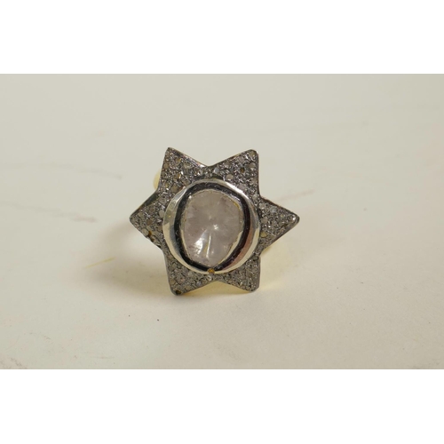 726 - A silver gilt dress ring in the form of a star, encrusted with uncut diamonds