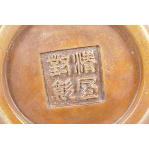 73 - A Chinese bronze censer with two elephant mask handles, impressed mark to base, 5½