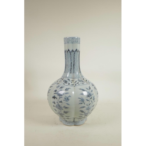 75 - A Chinese Ming style blue and white porcelain bottle vase of ribbed form, decorated with flowers, 14... 