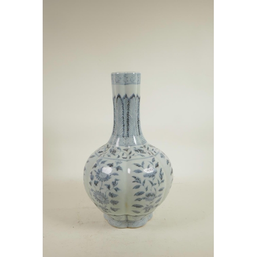 75 - A Chinese Ming style blue and white porcelain bottle vase of ribbed form, decorated with flowers, 14... 