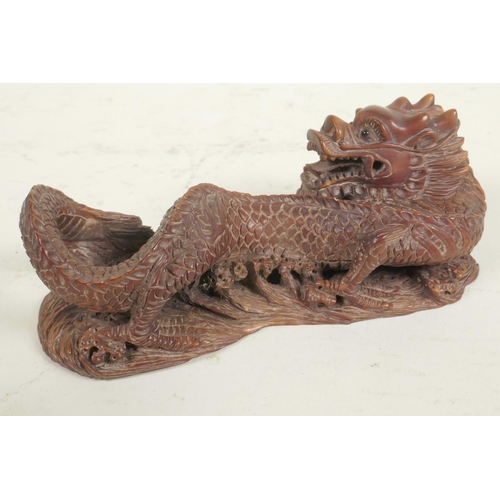 79 - A Japanese carved hardwood okimono of a dragon, 4½