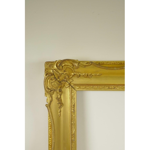 838 - A C19th gilt composition picture frame with C-scroll decoration, rebate 20