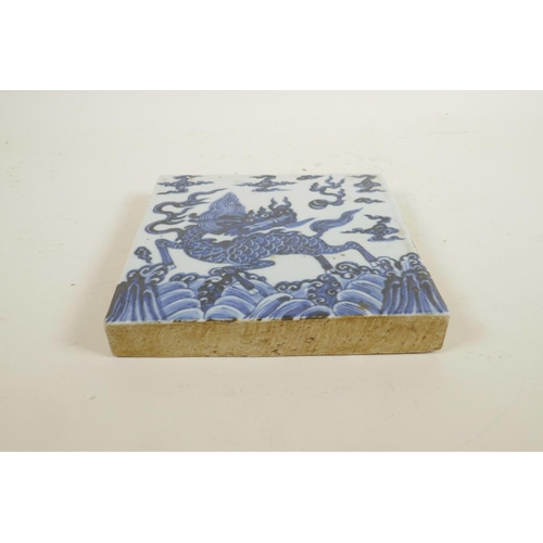 85 - A Chinese blue and white porcelain temple tile decorated with a kylin, 8