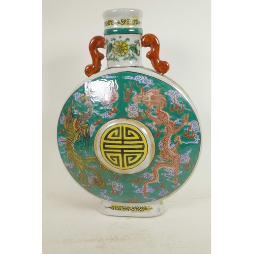 9 - A Chinese porcelain pilgrim flask decorated with fiery dragons on a green ground around a symbolic b... 