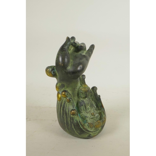 92 - A Chinese filled bronze figure of Buddha seated beneath a meditative hand, seal mark to base, 7½