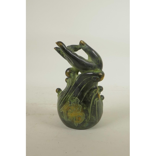 92 - A Chinese filled bronze figure of Buddha seated beneath a meditative hand, seal mark to base, 7½