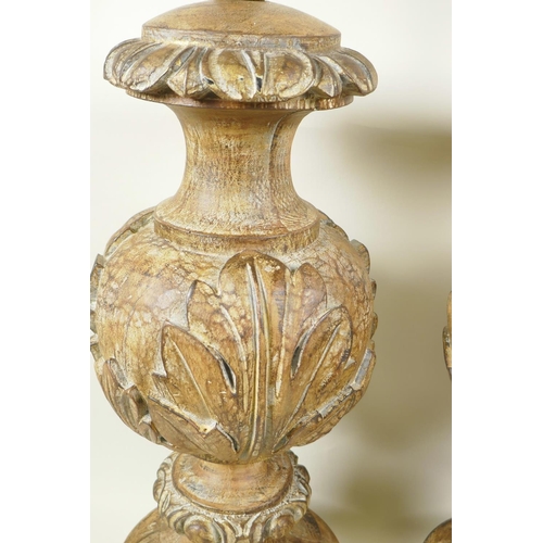 15 - A pair of parcel gilt table lamps carved with acanthus leaves, 21