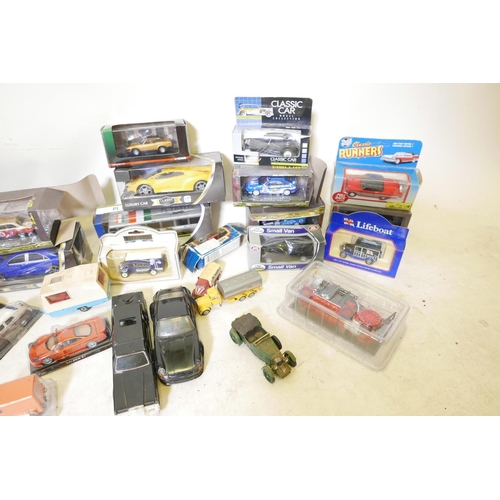 21 - A quantity of scale model cars, commercial vehicles and motorcycles