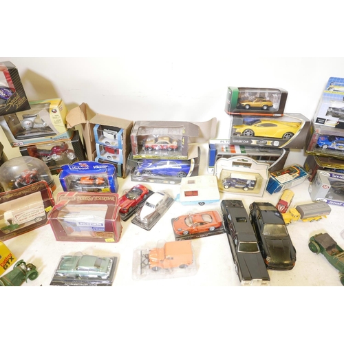 21 - A quantity of scale model cars, commercial vehicles and motorcycles