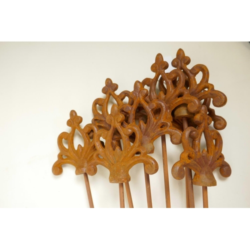 27 - Eight Gothic style decorative iron plant stakes, 42½